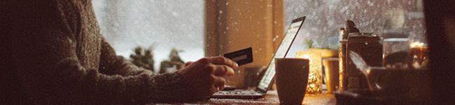 A male shopping on a laptop with snow in the background