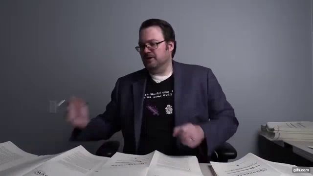 a man wearing glasses and a black shirt that says ' i 'm not a woman '