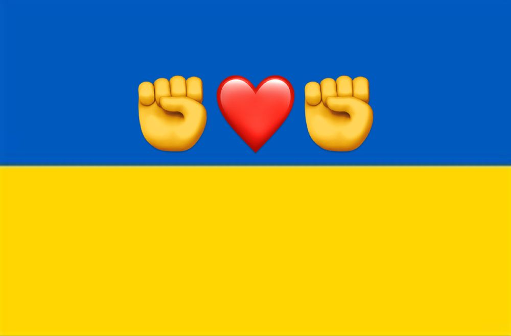 Ukrainian flag with solidarity fists either side of a red heart