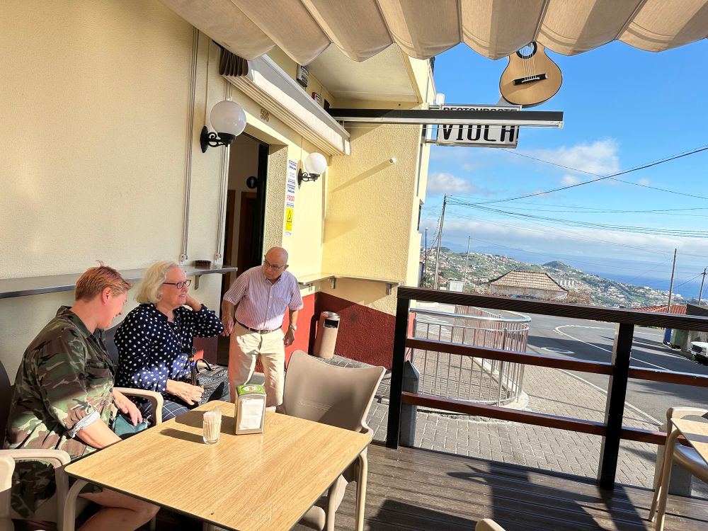 Blue skies in Câmara dos Lobos in distance. Kate and my parents outside the Viola restaurant waiting to be seated.