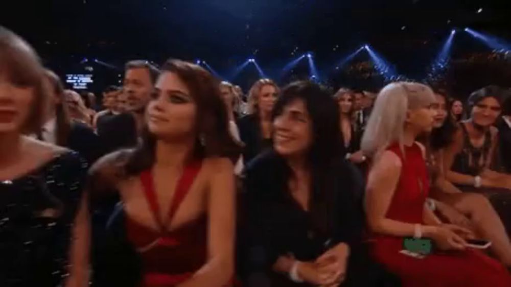 a group of people are sitting in a stadium watching a performance .