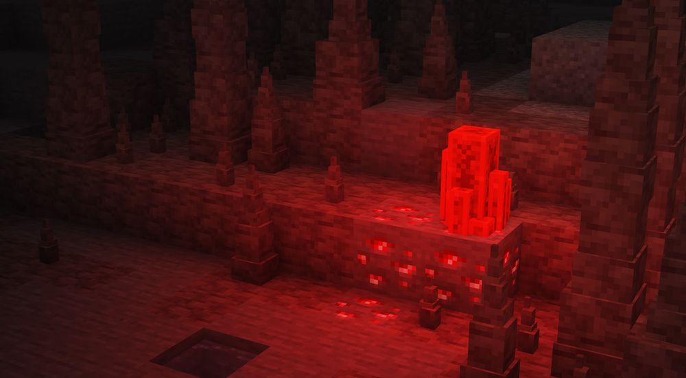 Minecraft: a redstone formation surrounded by 3d dripstone in a stone cave