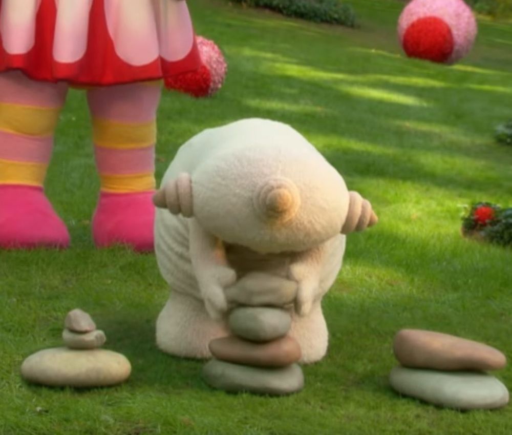 Makka Pakka from The Night Garden, stacking stones into suspiciously Blair-Witch-like formations.