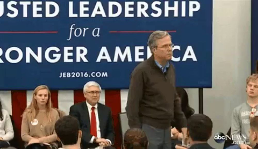 a man is standing in front of a sign that says ' usted leadership for a stronger america '