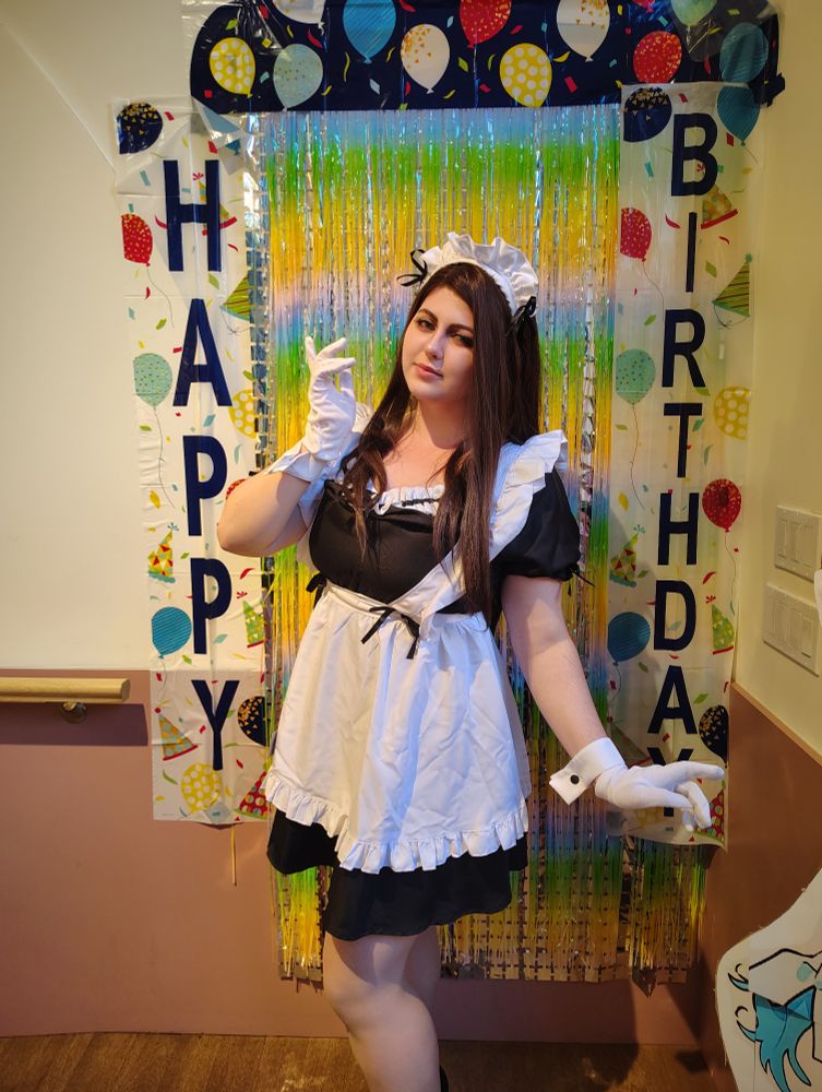 Photo of @mad_ace_cos cosplaying Hyuna in a maid costume, posing in front of the Happy Birthday decor.