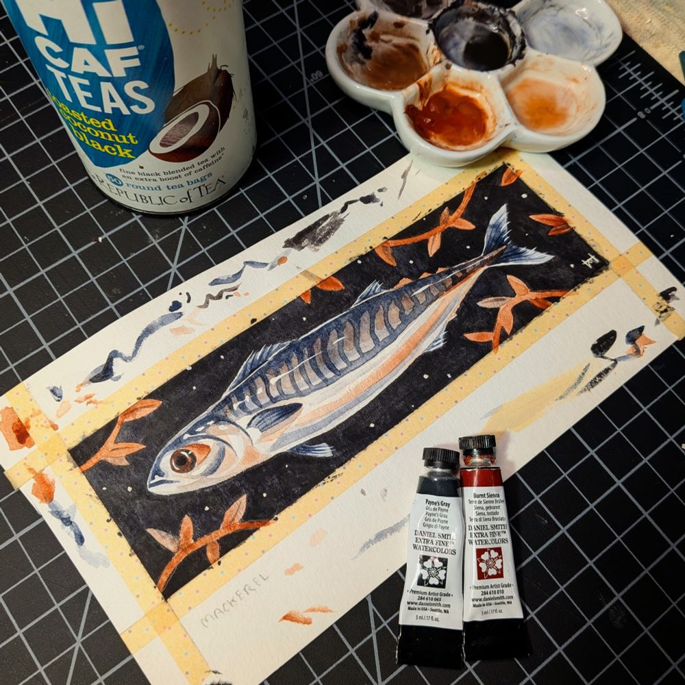 Photo of a watercolor painting depicting a lil fish against a black background, with leafy vines around the border