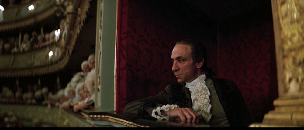 Antonio Salieri (F. Murray Abraham) looking imperiously down at everyone as they enjoy The Marriage of Figaro in Amadeus (1984).
