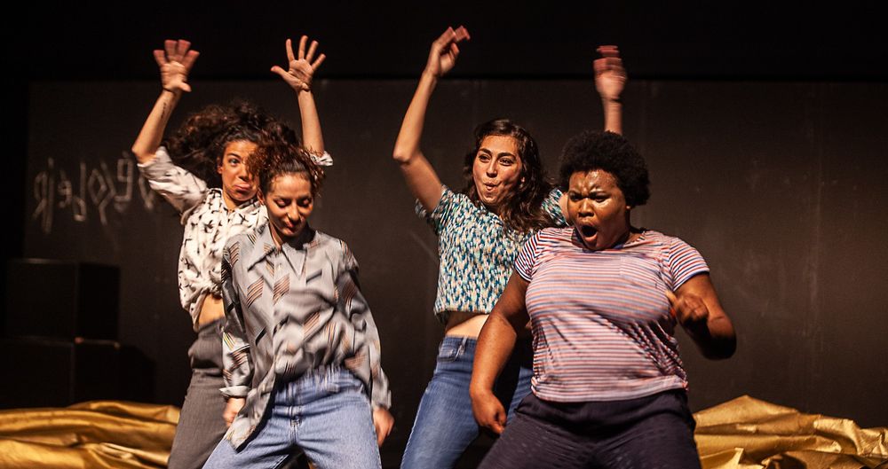 Quatre jeunes femmes dansent sur scène.