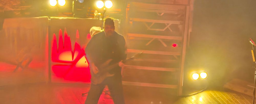 Large man playing bass guitar