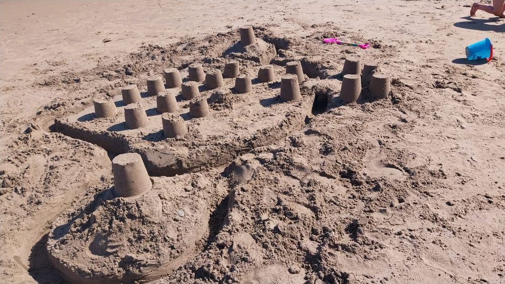 A sandcastle fort of such joy, it is enough to make some weep, and others swoon. Regard the snaking moat, the causeway entrance, and the watchtowers. This is a thing of joy, friends. Of joy. 

It was trampled to death by my children some 2 minutes after this before being washed by the tide. Goodnight sweet Prince, flights of angels sing thee to thy rest.