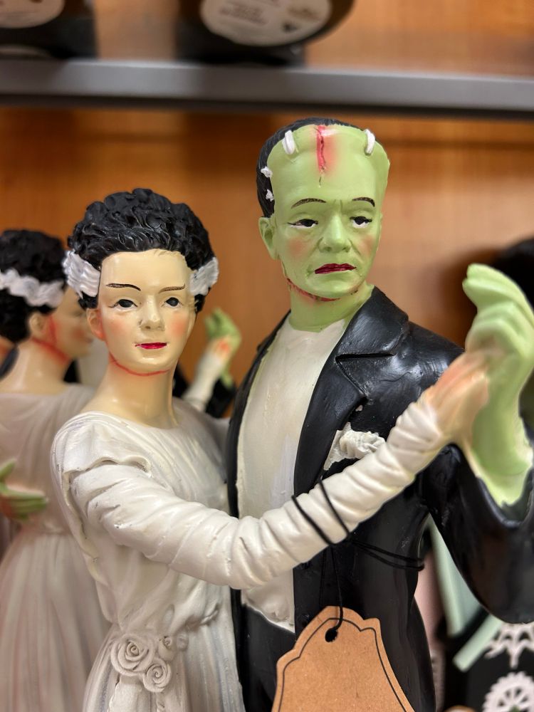 Poorly painted bride of Frankenstein and Frankenstein statues 