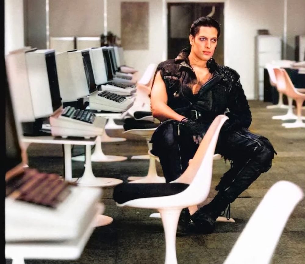 80s Kurgan in black leather in a computer lab for some reason 