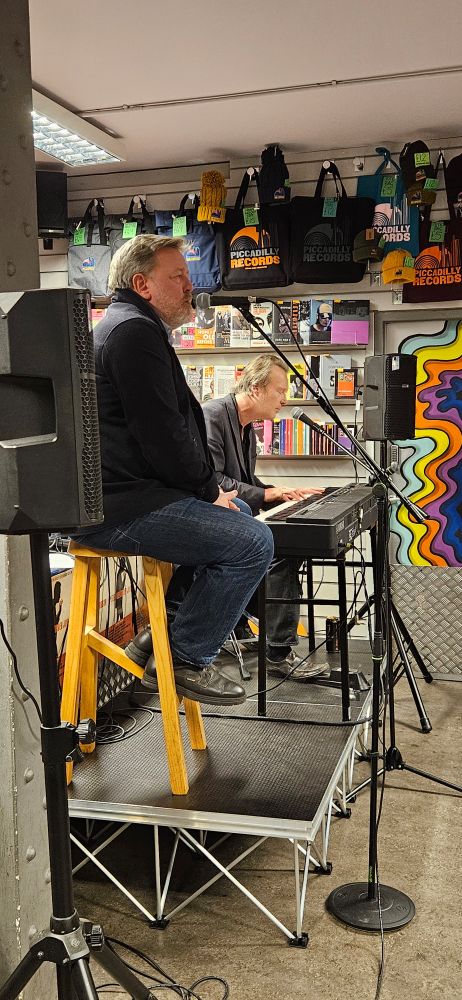 Peter Alexander Jobson playing instore at Piccadilly Records accompanied by Guy Garvey, lead singer of the band Elbow.