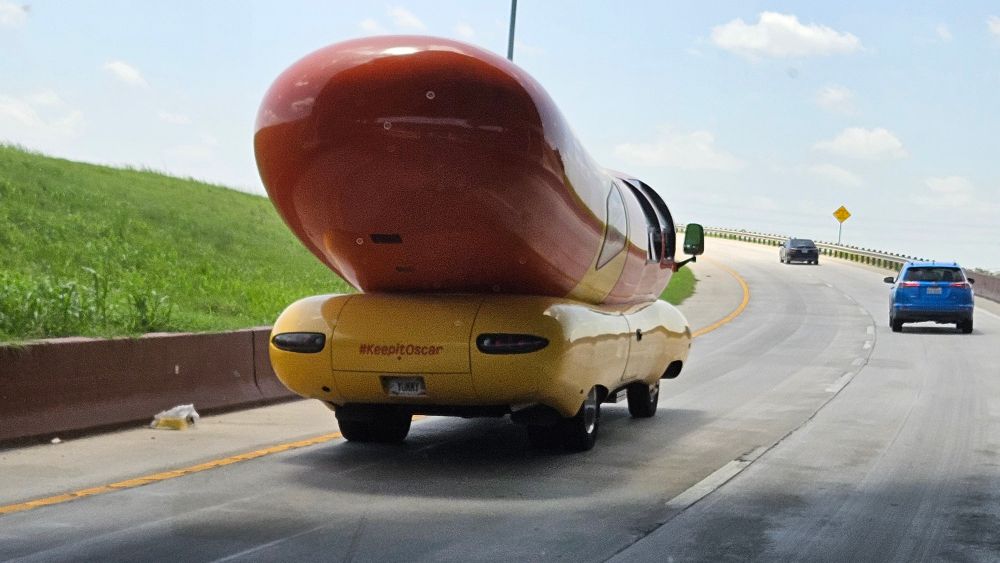 Shot of back of an Oscar-Meyer Weinermobile from highway