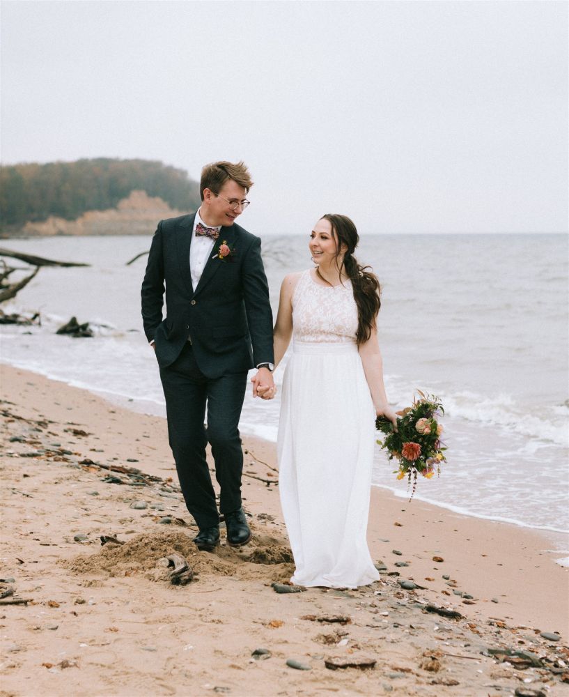 Walking along the beach at Calvert Cliffs in our wedding clothes