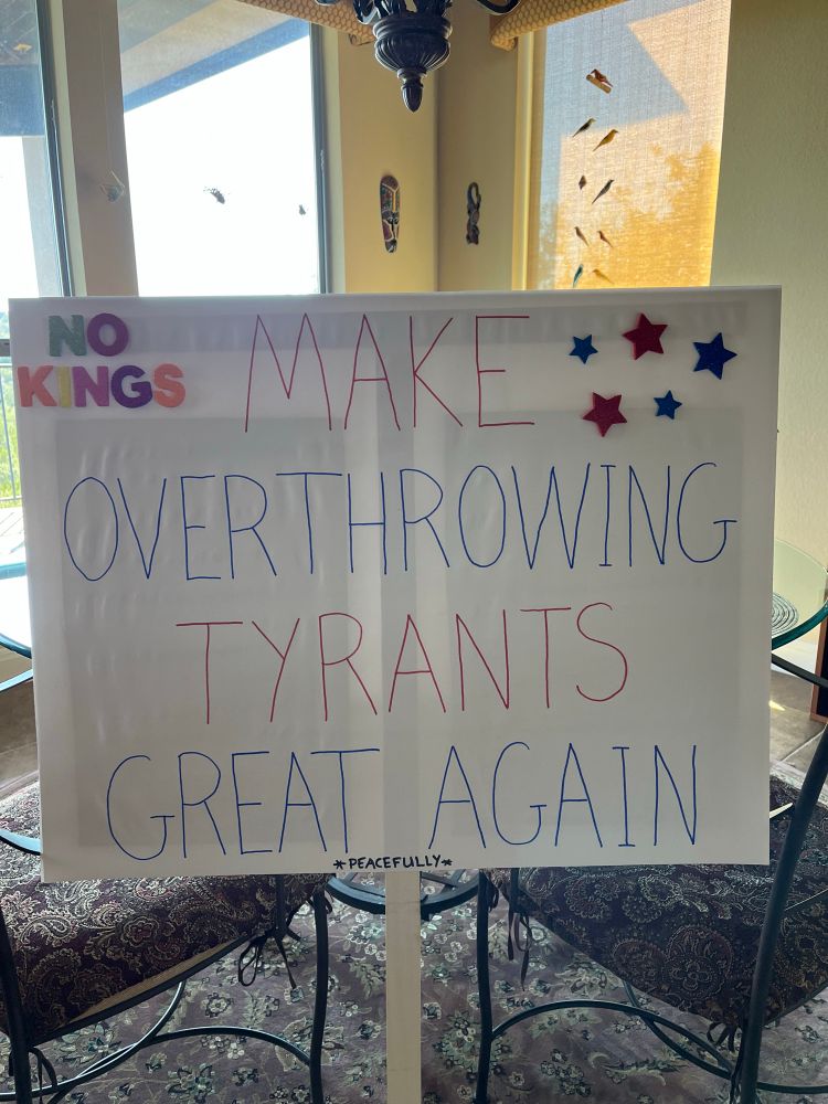 A homemade No Kings sign that says “Make Overthrowing Tyrants Great Again “