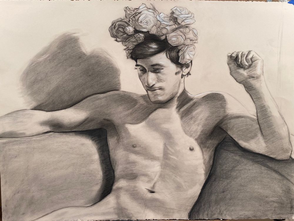 A drawing of a man with a flower crown in charcoal