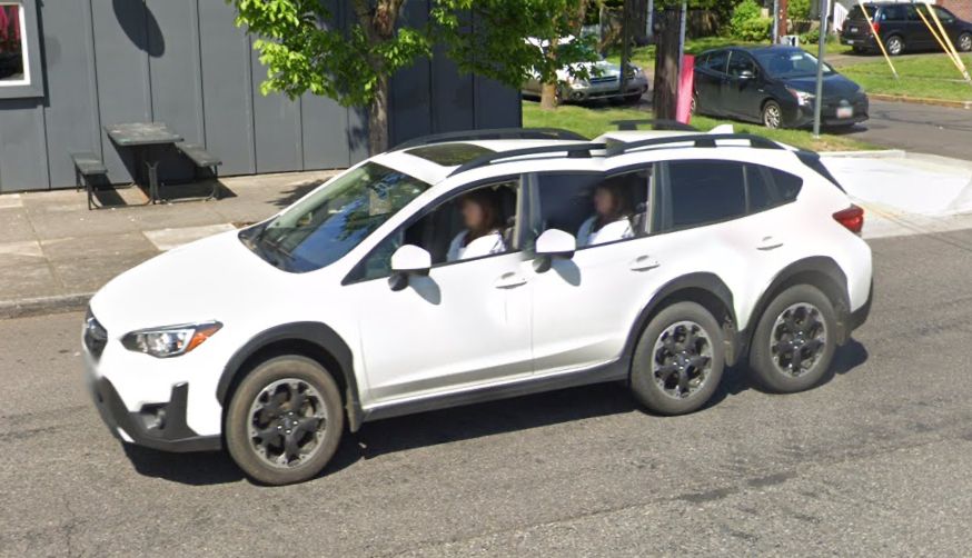 A glitched screenshot from Google Street View shows a white Subaru hatchback with an extra set of rear wheels.