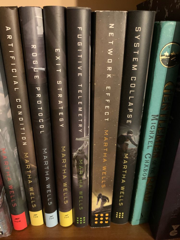 The spines of the seven Murderbot books