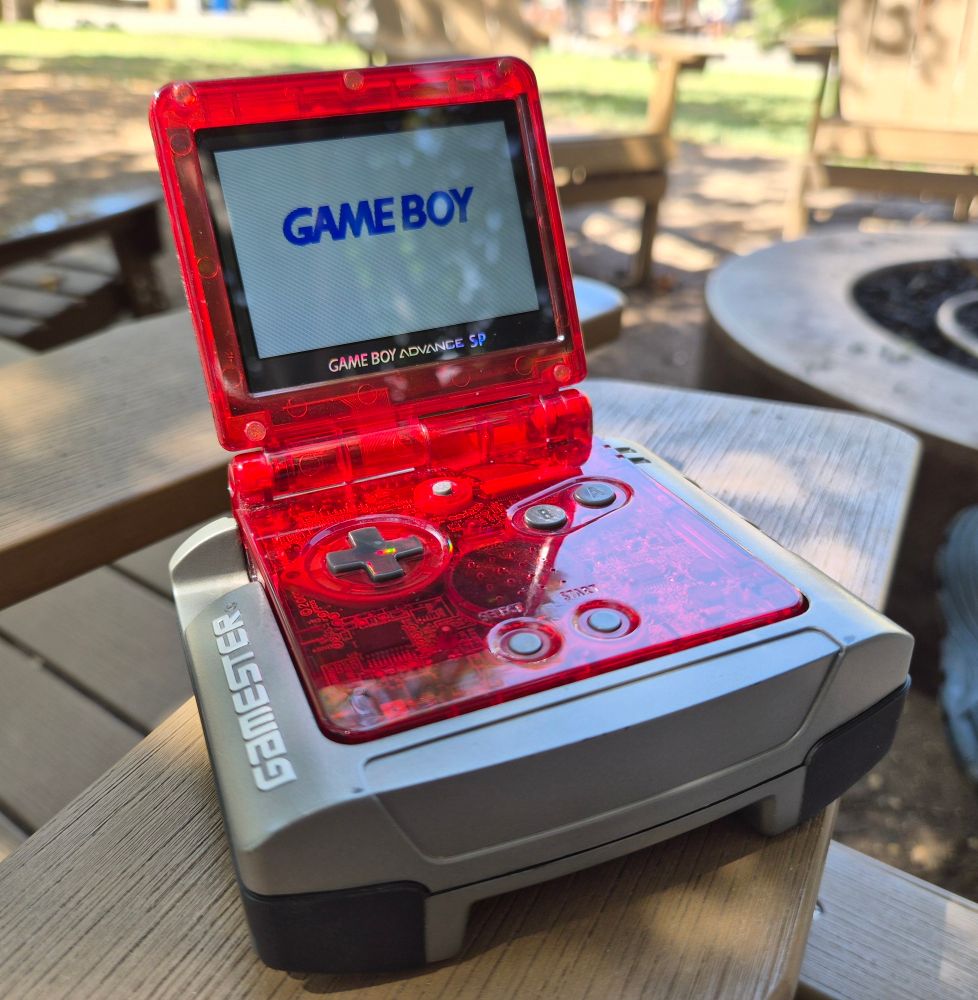 GBA SP with a FunnyPlaying IPS kit and shell. It's inserted into a Radica Gamester.