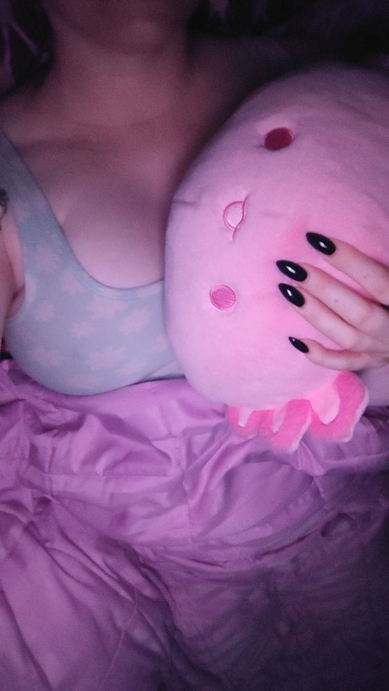 Laying in bed with my axolotl plushie