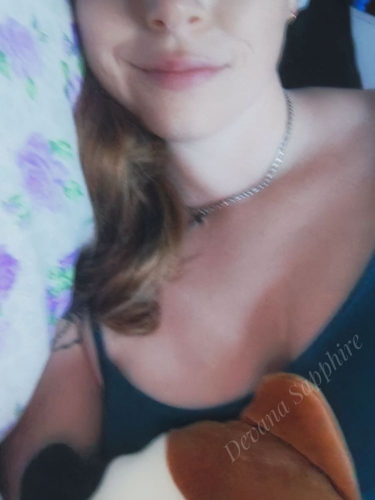 I'm laying in bed with a Squishmallow and wearing a green blue nightgown