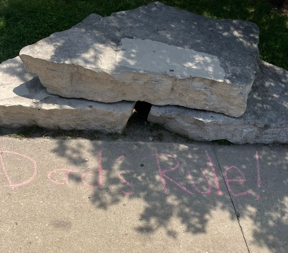 Sidewalk, written in chalk is “Dad’s rule!”