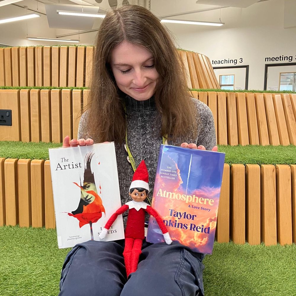 Image shows Lauren holding 2 books featured in this post along with the Library Elf.