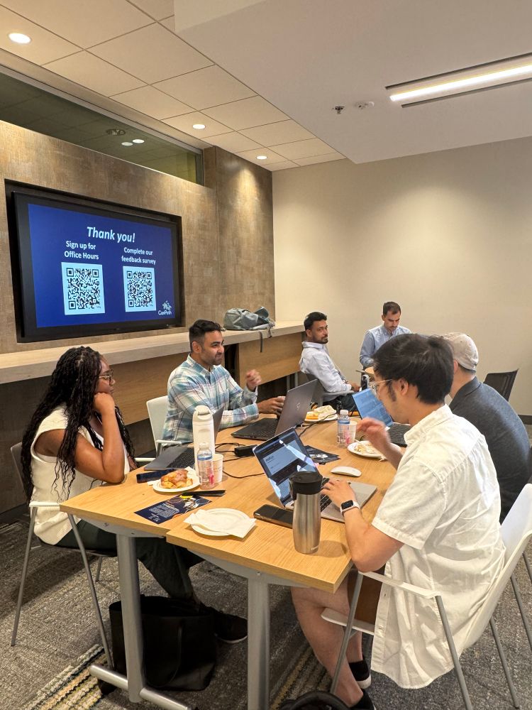 Attendees at a workshop table discussing