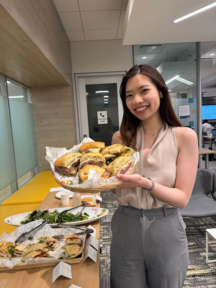 Nguyet holding up sandwiches