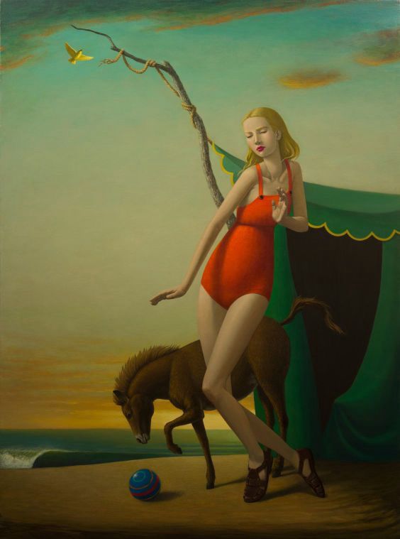 Surreal scene by John Tarahteeff showing a young woman in a red swimsuit posing gracefully on the sand in front of a green tent. Beside her, a small horse leans forward, investigating a colorful ball. The calm sea and a yellow bird in flight form the background, creating a delicately magical atmosphere.
