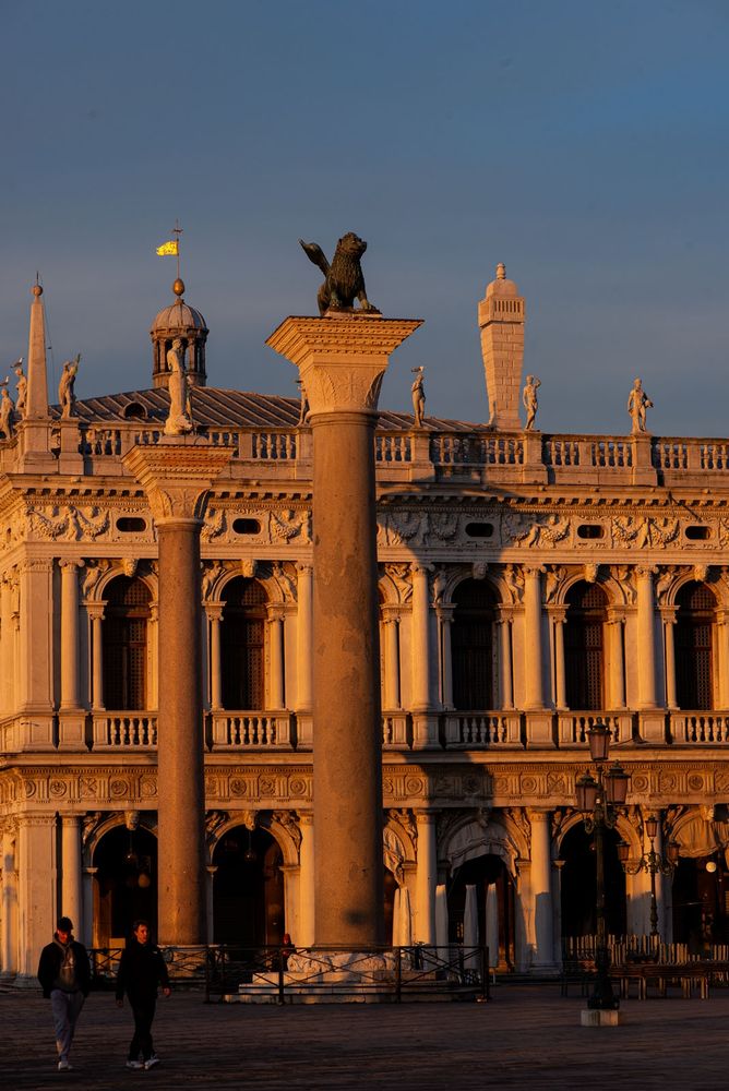 A few early tourists explore Venice's St Mark's Square at sunrise. It was a chilly morning, and I had been out in the cold for hours. For me the early light meant that it was finally time to return to my hotel and get some hot drinks and a breakfast roll.