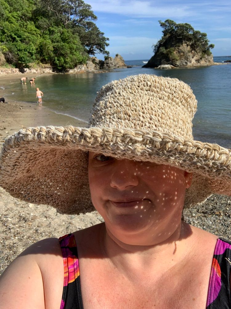 Me in a sun hat at the beach. 