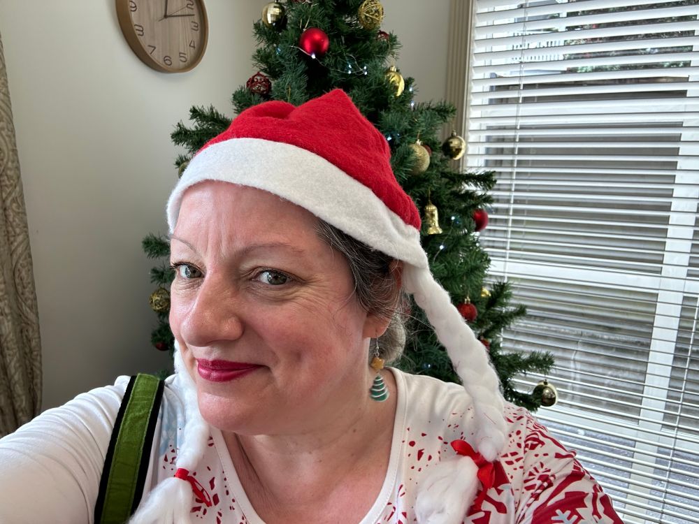 A close up of my (very tired) face to show the Christmas tree earrings. 