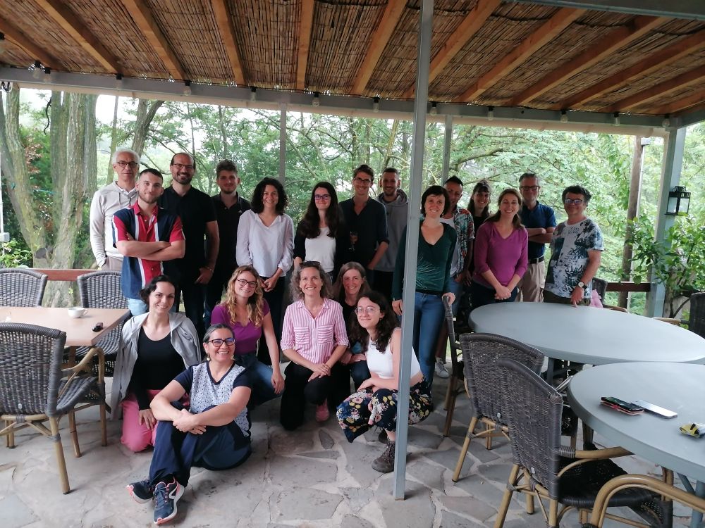 Many collaborators, young and not that young, posing for the photo