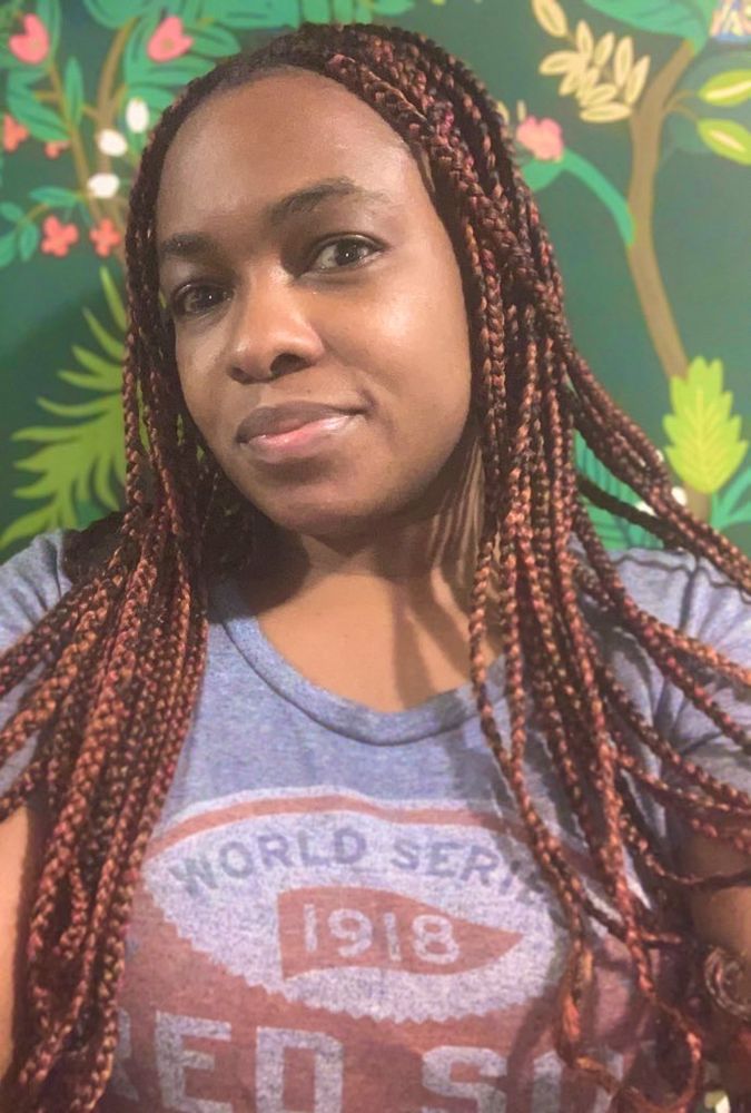 Middle aged Black woman with autumn colored braids