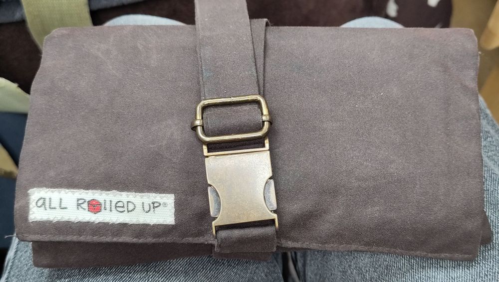 Oilskin all rolled up with brass buckle