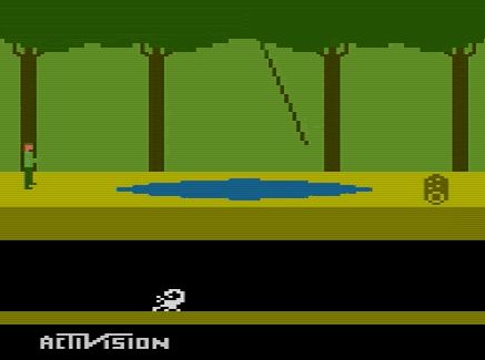 A screenshot of the Atari 2600 video game “Pitfall!” featuring a sparse forest, a log, a vine swinging over a pond, a subterranean scorpion, and the player hero. 