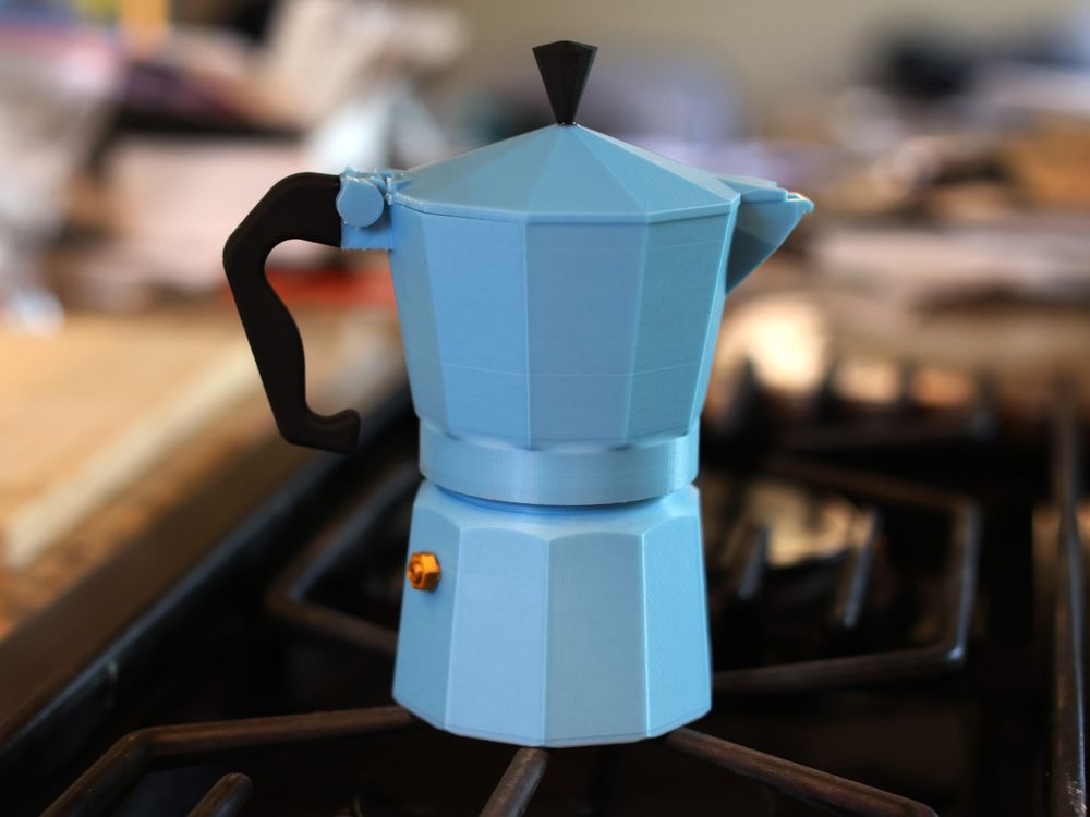 A classic stovetop espresso maker 3D printed in glow-in-the-dark plastic (periwinkle), sitting calmly on the stovetop, which is not lit.