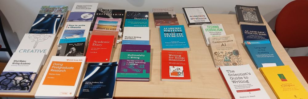 Photo of several books on academic writing, academic literacies, multimodal, creative, and sociological scholarship on writing as a critical practice and language as power. The books are laid out on a table for display and browsing during our first in-person and hybrid lesson.