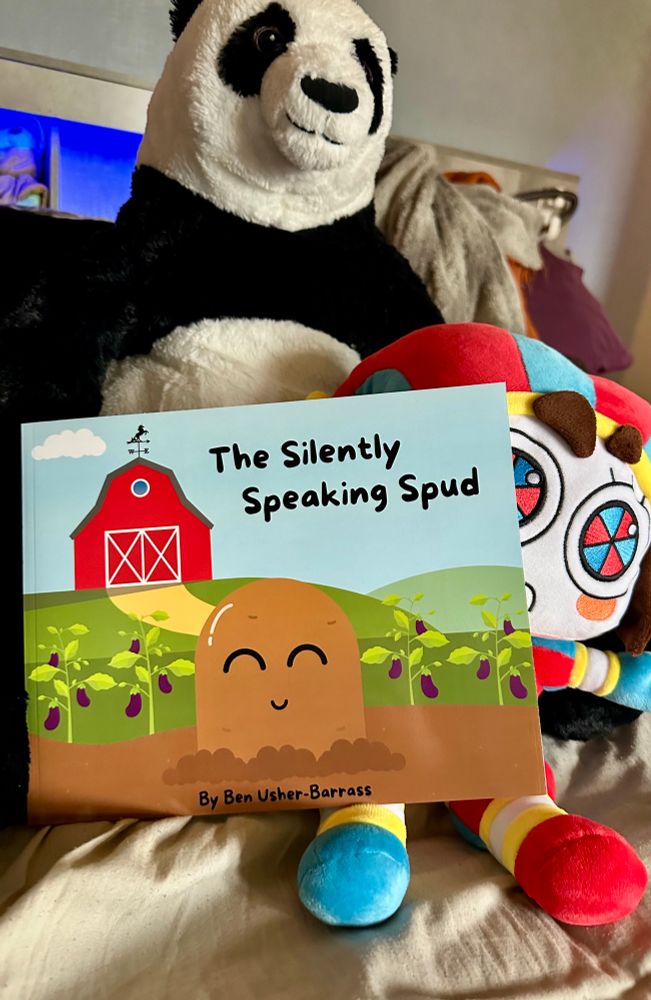 Photo of a stuffed panda, and Pomni doll holding a children’s book 