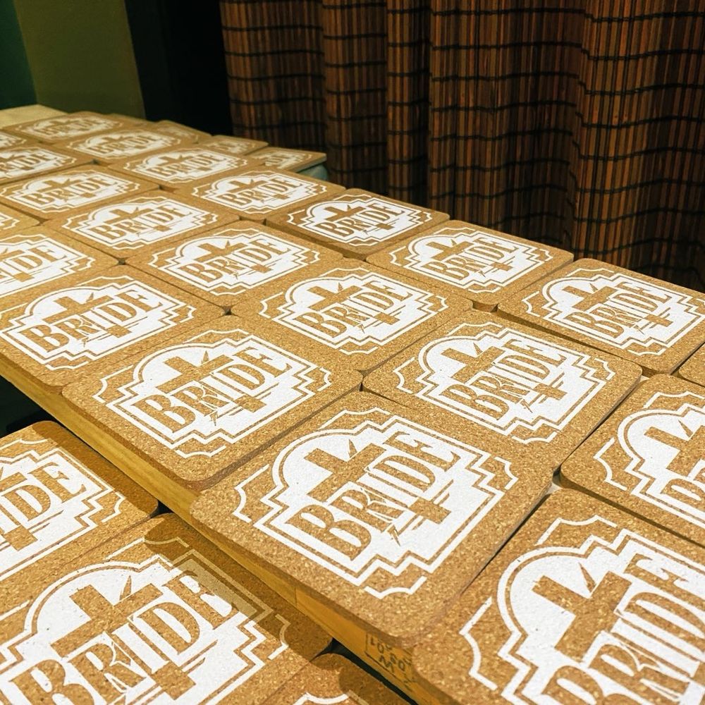 Rows of screen printed cork coasters with Bride logo