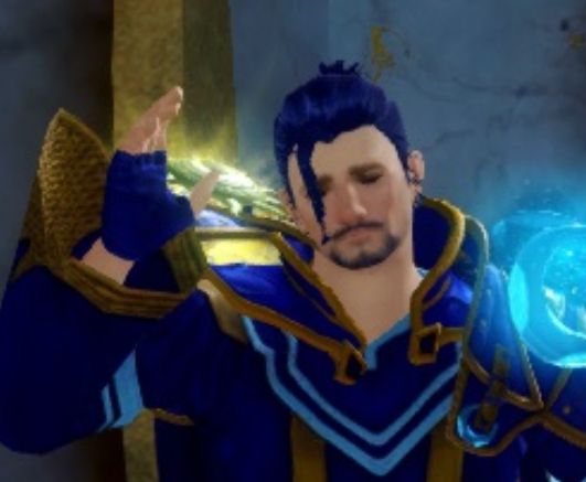 gw2 human with dark blue hair, looking so very sad and disappointed for some reason. his hand is raised.