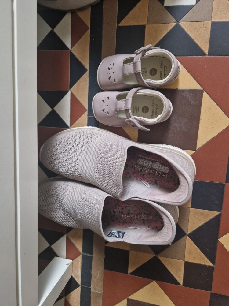 Adult shoes next to baby shoes