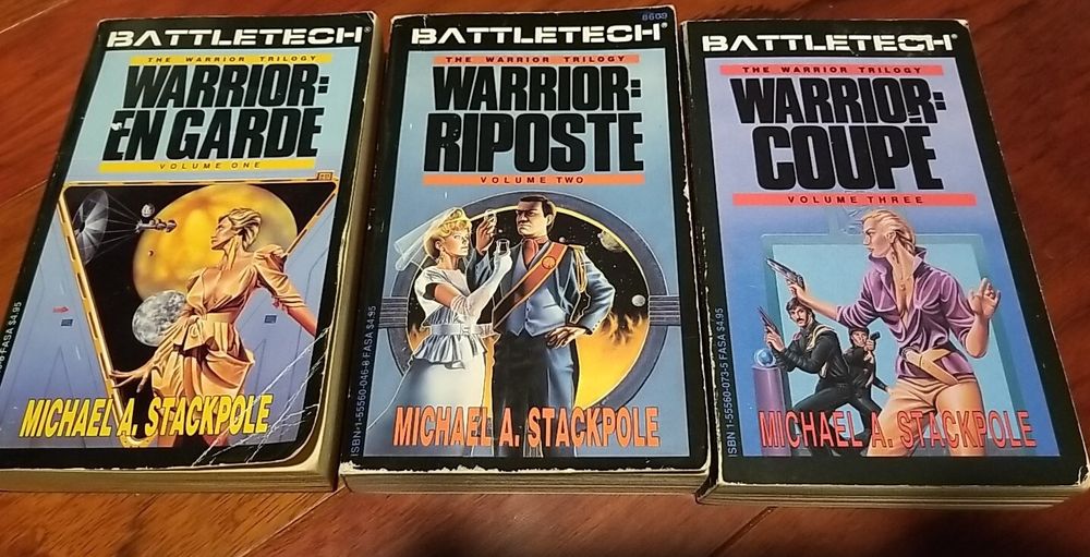 The original paperback editions of "Warrior: En Garde," "Warrior: Riposte", and "Warrior: Coupe." The covers all feature a white, blonde, woman. In the first, she is wearing a ball gown and looks out a triangular window, down on to a planet and moon over which orbits a jump ship (with parachute like sail behind it). For "Riposte," she is wearing a wedding dress and is toasting a white man wearing formal clothes and a sash. "For "Coupe," she is wearing a blouse & jodhpurs, and holds off two armed guards in black fatigues (all three are brandishing pistols). 