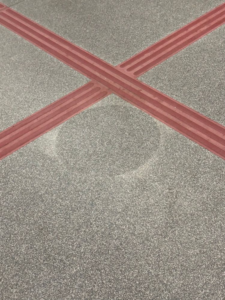 The outline of a covid era floor sticker on a subway car