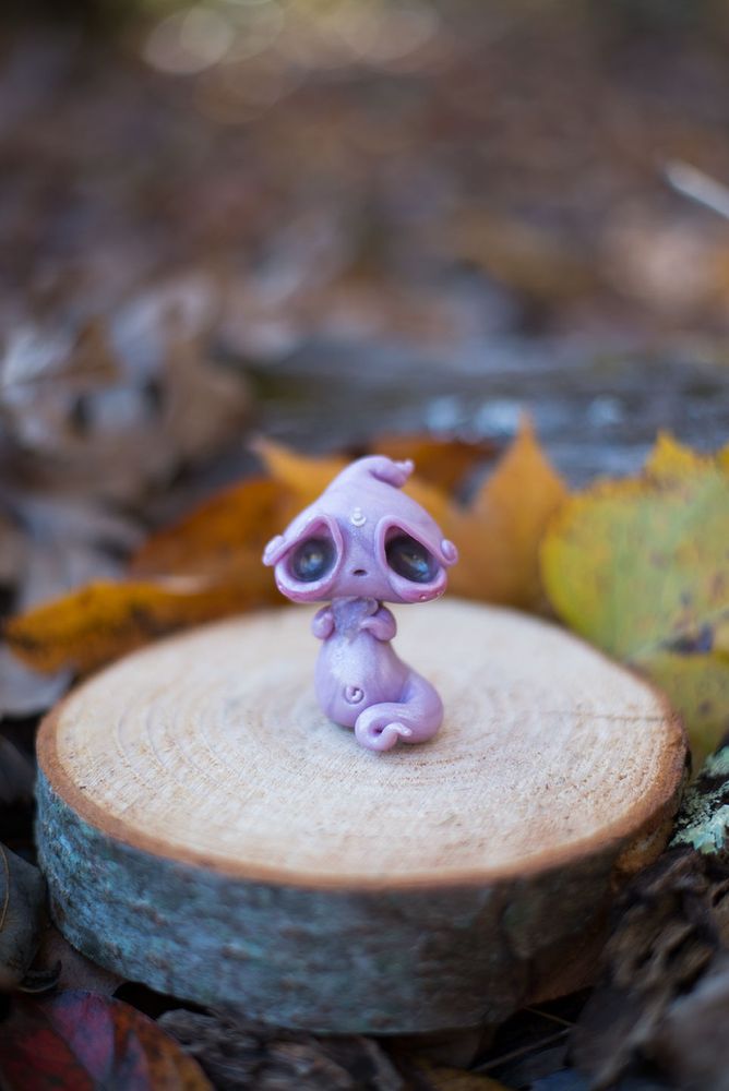 Handmade polymer clay ghost figurine sculpted in Mishes old art style of oversized head with huge, sad eyes, thin neck, and a plump belly & limbs.