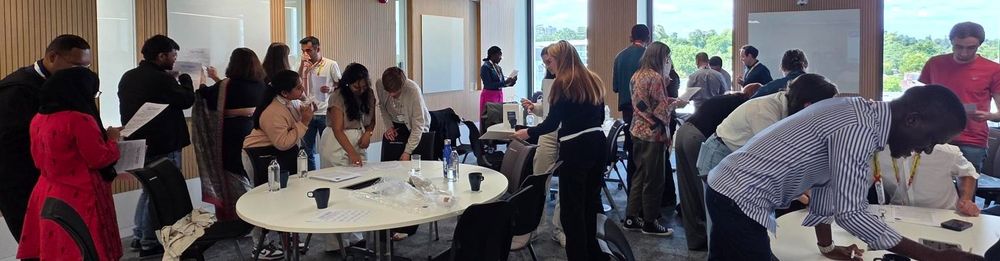 Images show delegates at #PopFest2025 taking part in the networking bingo game to meet other early career researchers of population studies