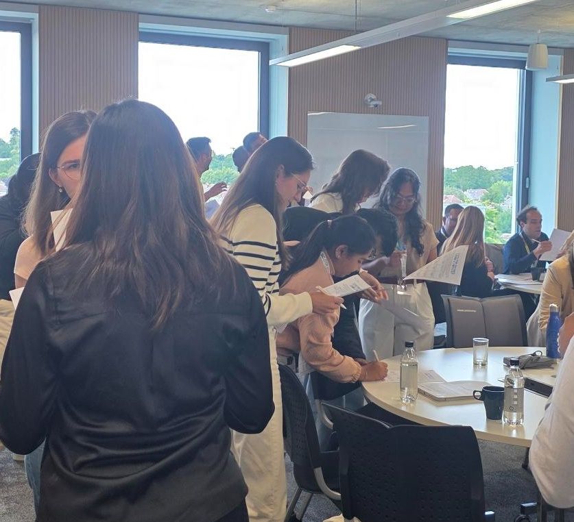 Images show delegates at #PopFest2025 taking part in the networking bingo game to meet other early career researchers of population studies
