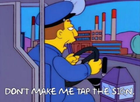 Scene from The Simpsons: bus driver saying "Don't make me tap the sign."